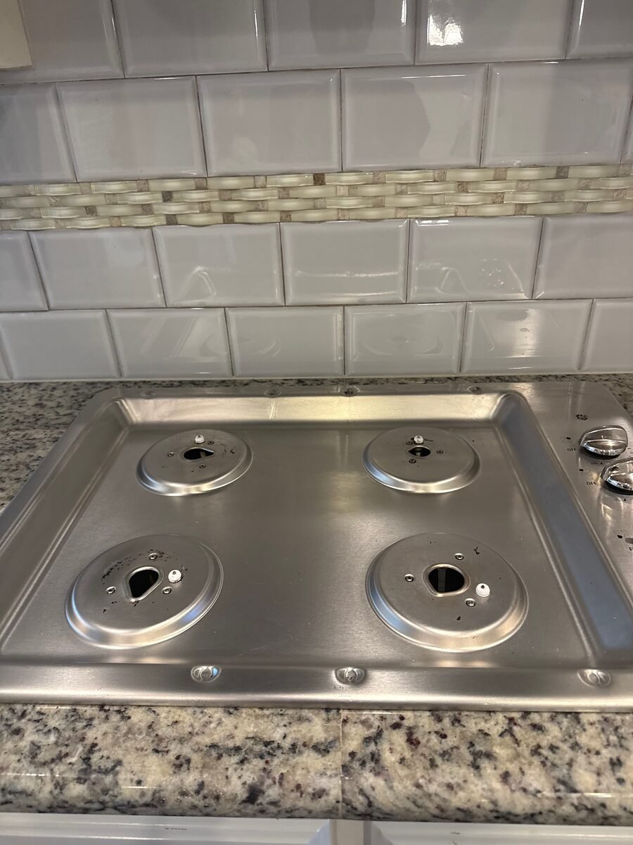 The same cooktop after cleaning, back to bare stainless steel