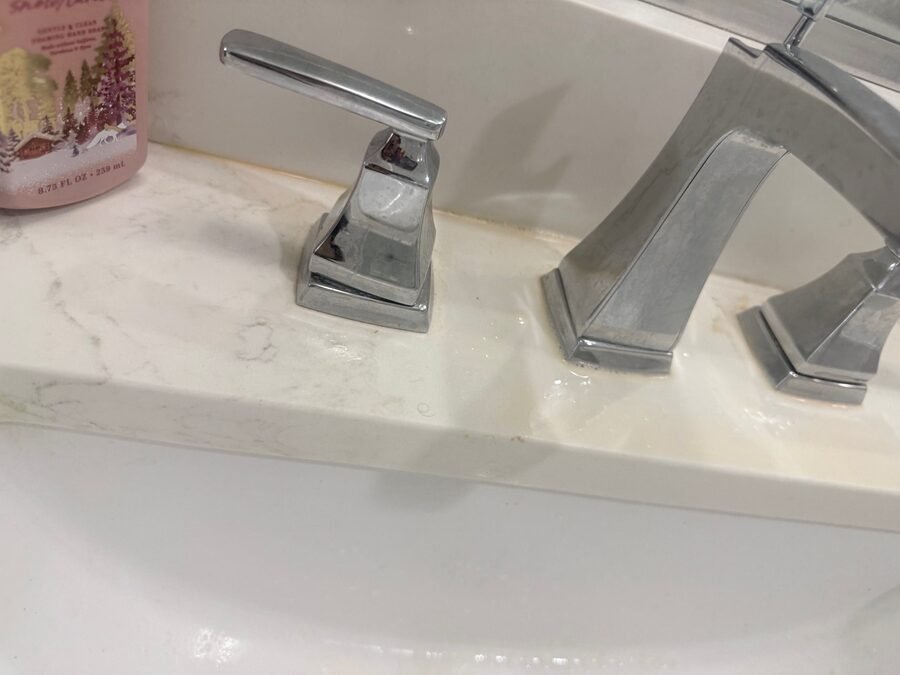 A bathroom faucet and basin cleaned to a shine