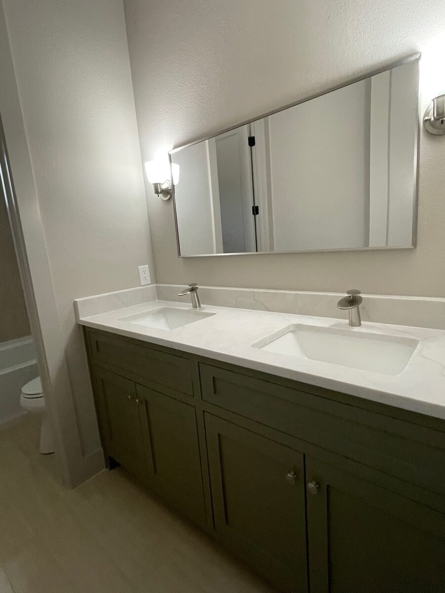 a double-vanity bathroom with a wide mirror in a Coppell home cleaned by SusyQ’s Cleaning