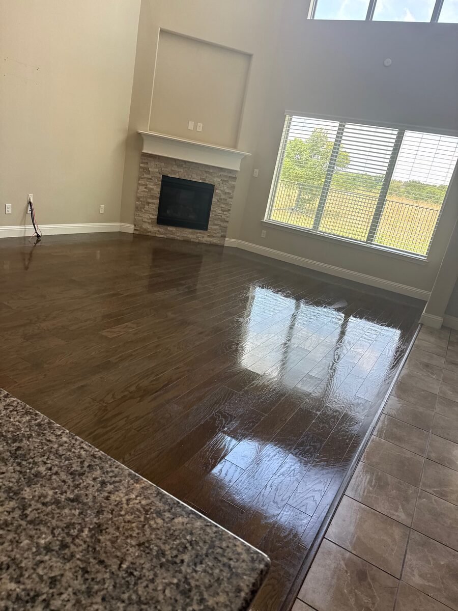 A hardwood floor in an empty room, cleaned ready for handover