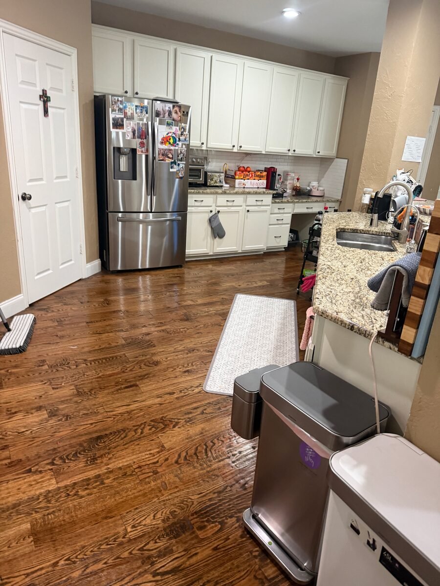 A kitchen with stainless appliances and the floor cleaned through