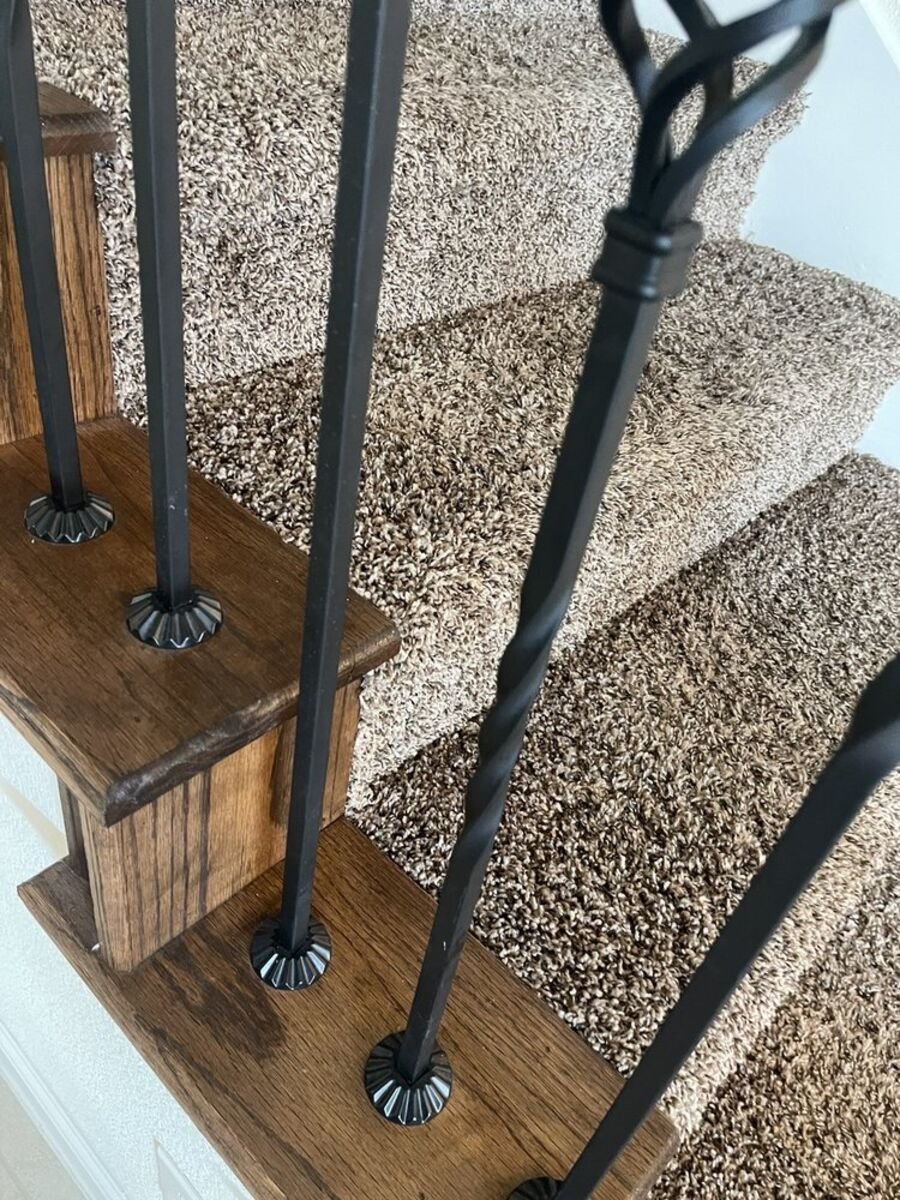 Carpeted stairs vacuumed clean between the balusters
